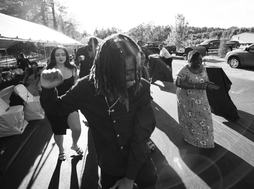 Black and white film style guests dancing